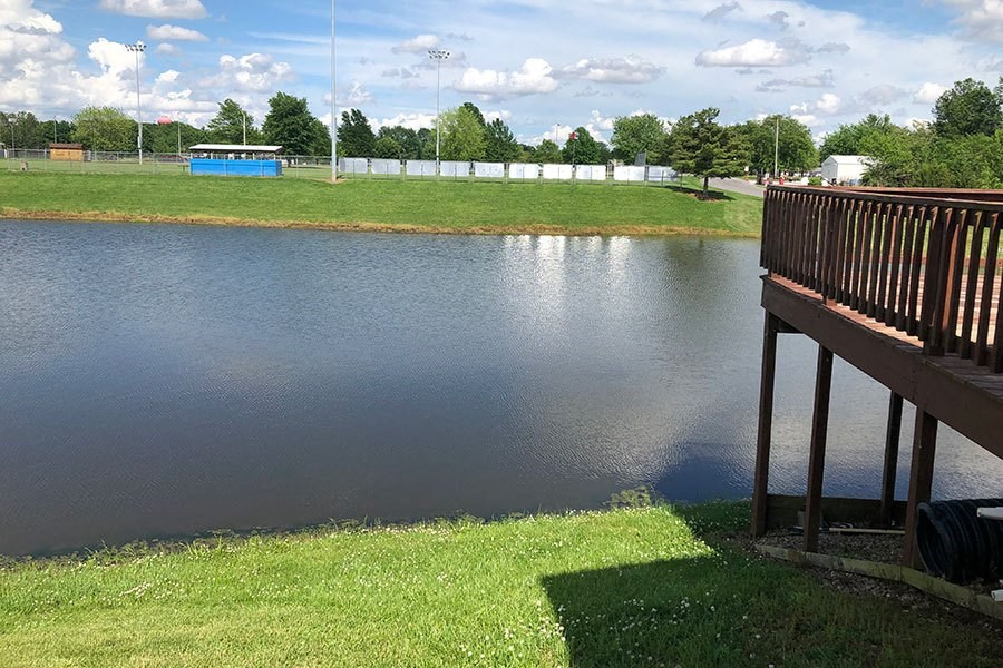 a wooden bench sitting next to a body of water