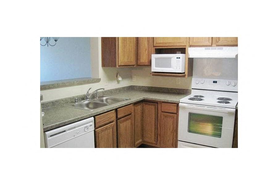 a kitchen with a stove microwave and sink