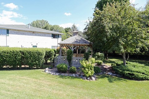 a gazebo in the yard of a house