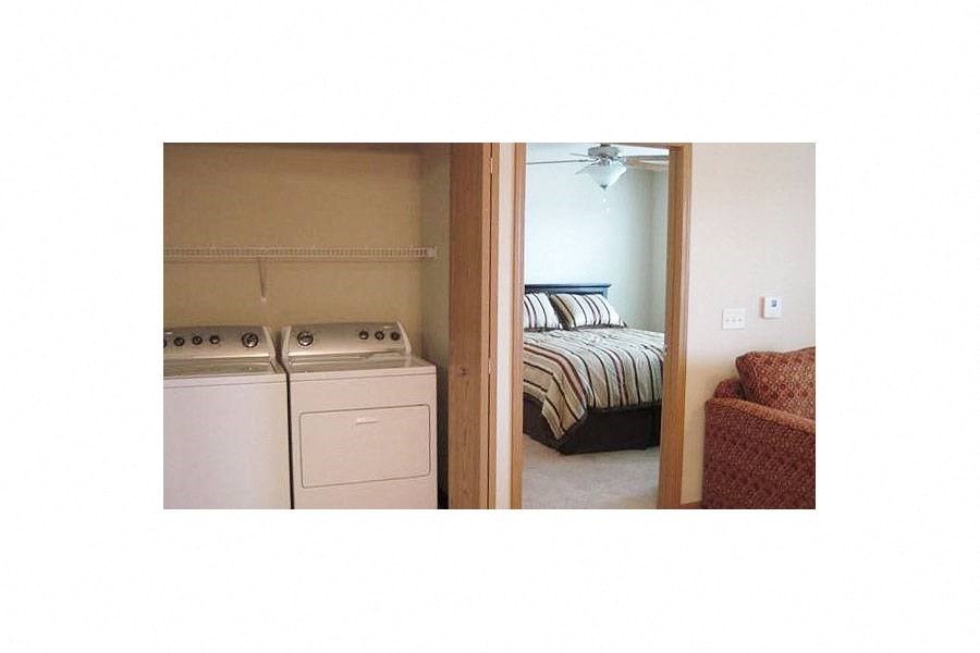 a room with a stove and a bed in it