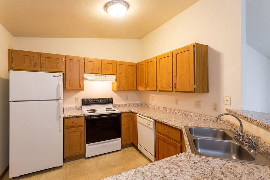 a kitchen with a stove refrigerator and sink