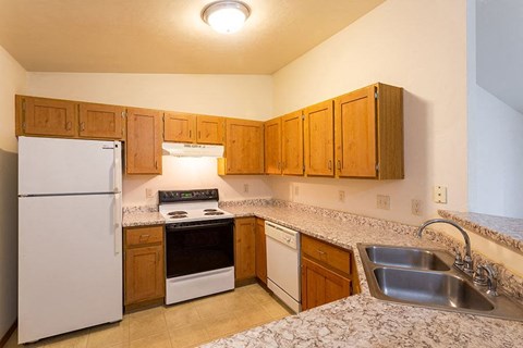 a kitchen with a stove refrigerator and sink