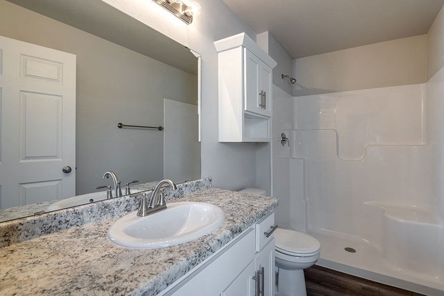 a white bathroom with a sink and a toilet