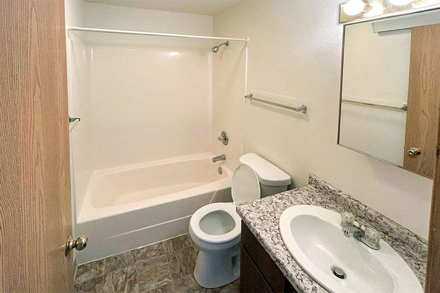 a bathroom with a toilet and a sink and a shower