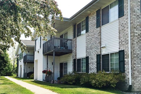 a brick and white building with a balcony