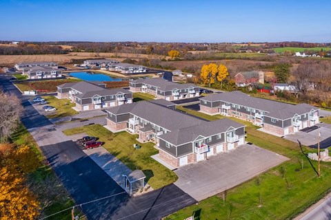 A large building complex with a pool in the middle.