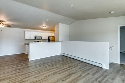 A kitchen with white cabinets and a microwave above the counter.