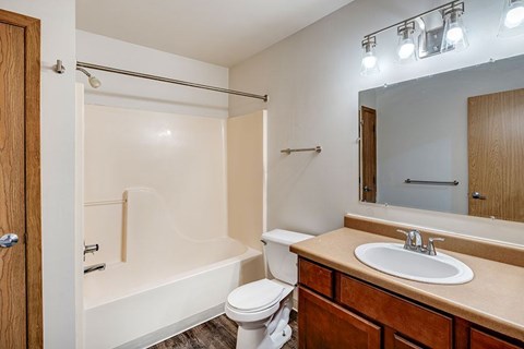 A bathroom with a white toilet, a white sink, and a white bathtub.