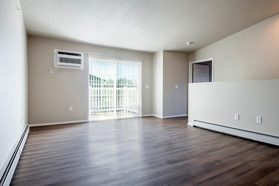 A room with a window and sliding glass door.