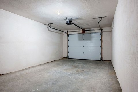 A white garage door is closed and locked.