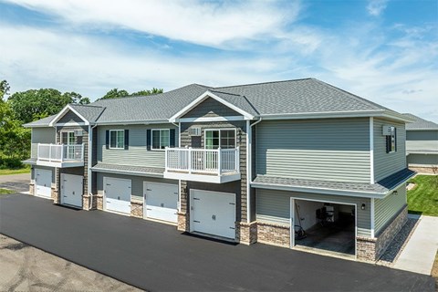 A two-story house with a garage on the lower level.