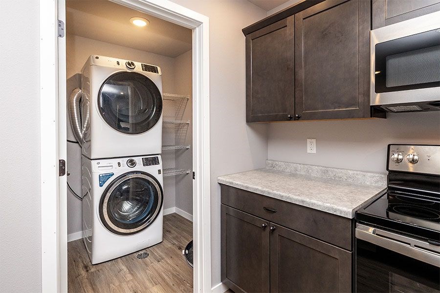 A small laundry room with a washer and dryer stacked on top of each other.