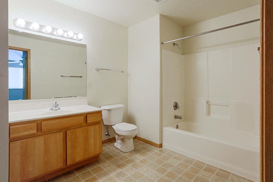 a bathroom with a toilet and a sink and a tub