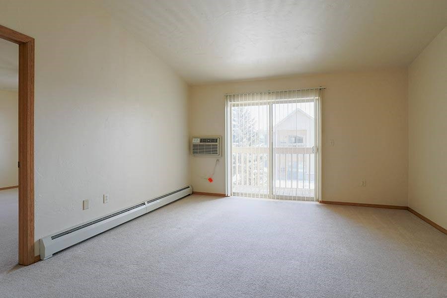 an empty living room with a sliding glass door