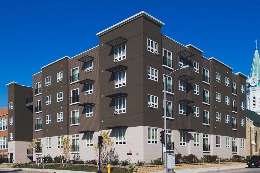 a large building with a clock tower in front of it