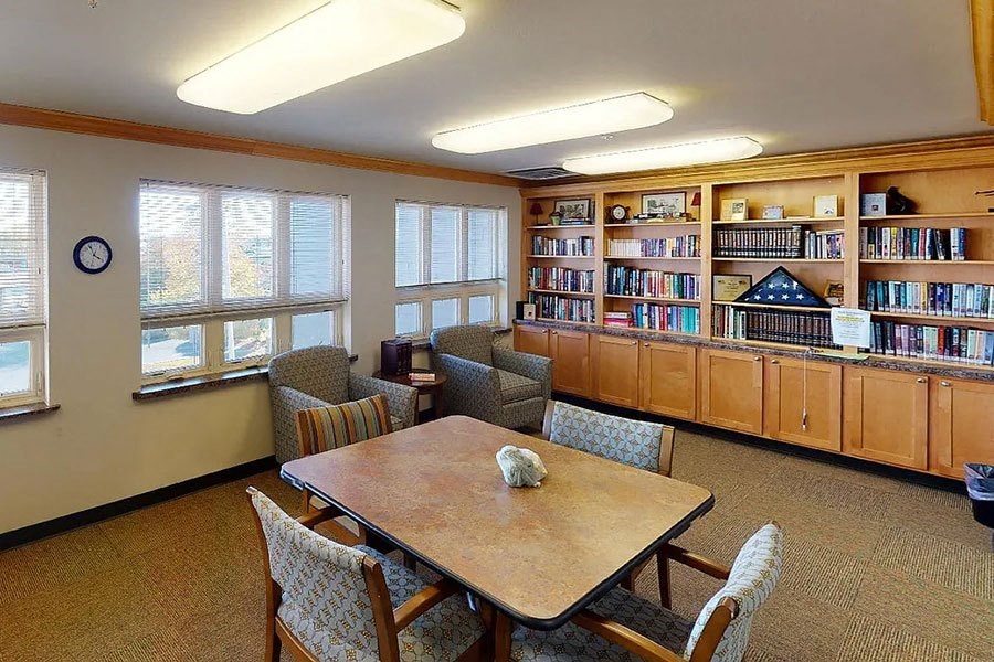 a library room with a table and chairs