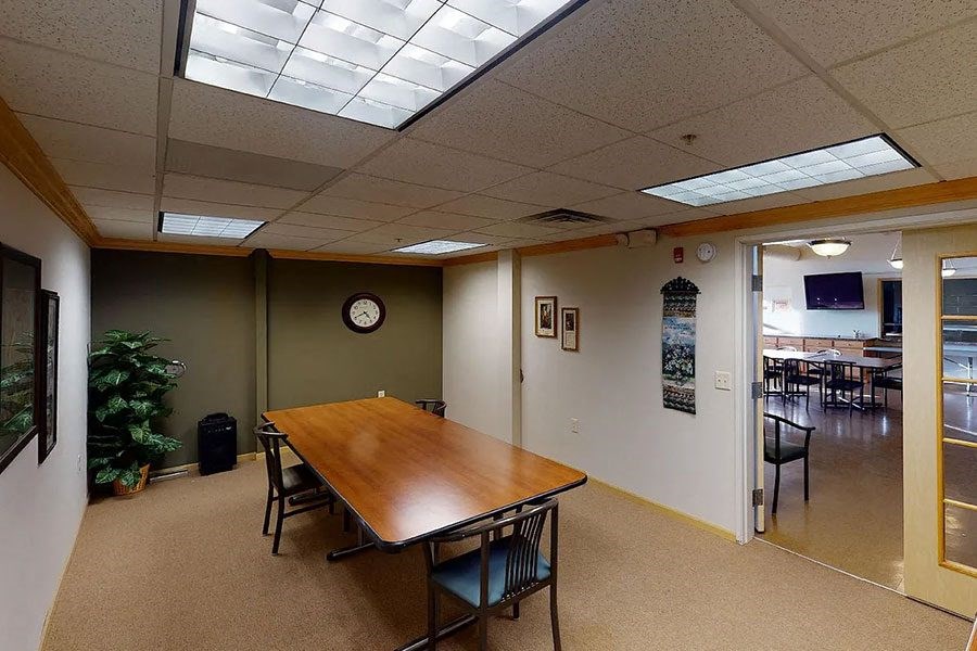 an empty room with a table and chairs