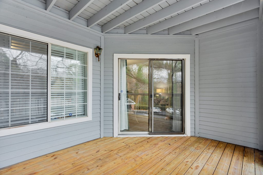 a room with a wooden floor and a glass door