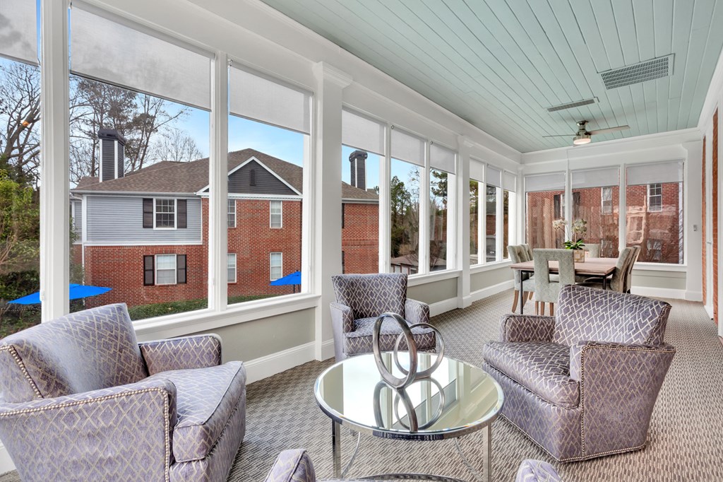 a living room with couches and chairs and a glass table