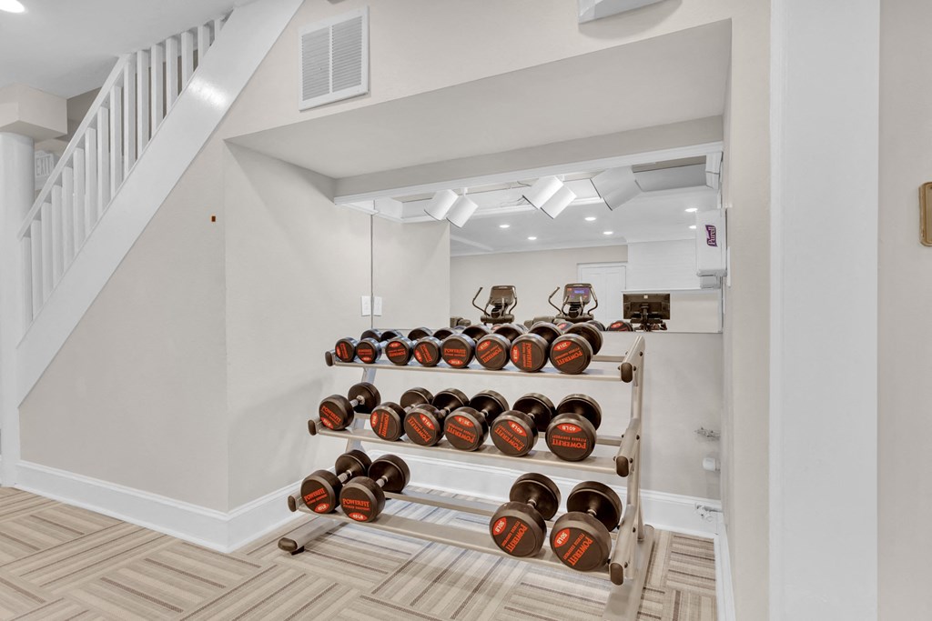 a rack of wine bottles in a room with stairs