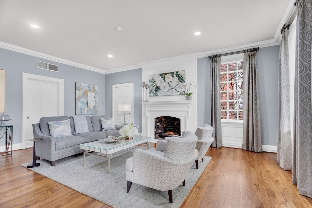 a living room with two couches and chairs and a fireplace