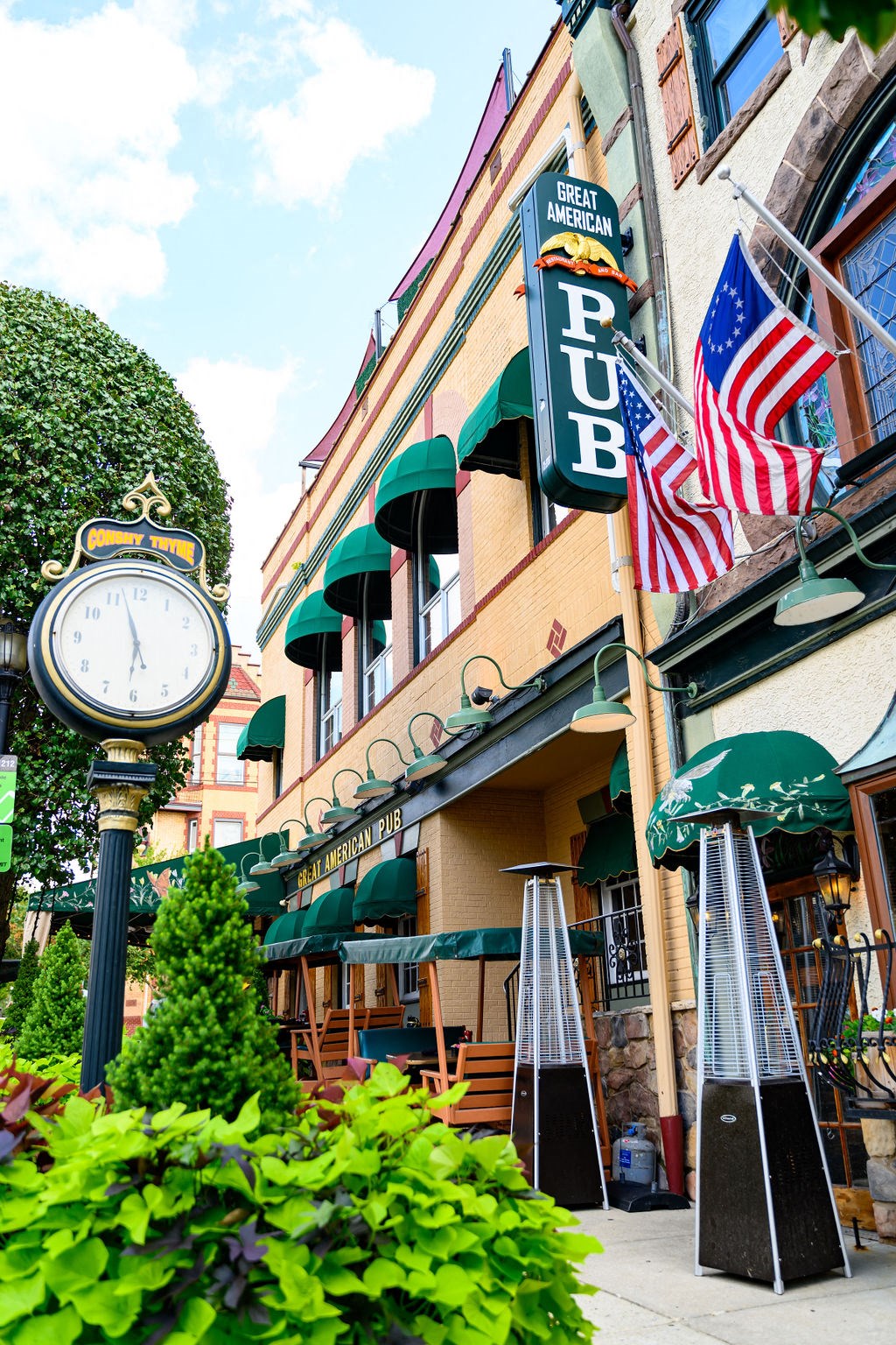 a clock on the sidewalk in front of a building at Madison West Elm, Conshohocken