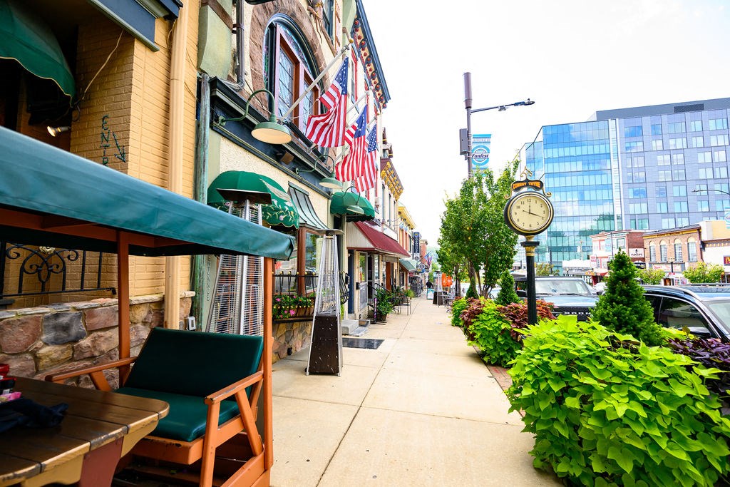 a sidewalk with a clock on the side of a building at Madison West Elm, Conshohocken, Pennsylvania