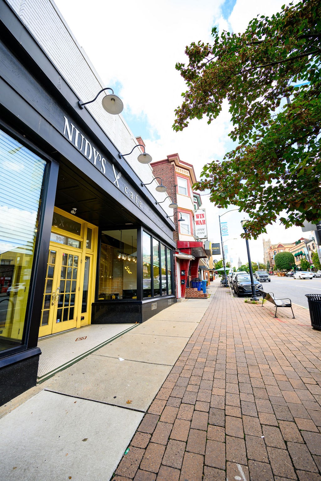 a sidewalk in front of a store on a city street at Madison West Elm, Conshohocken, PA