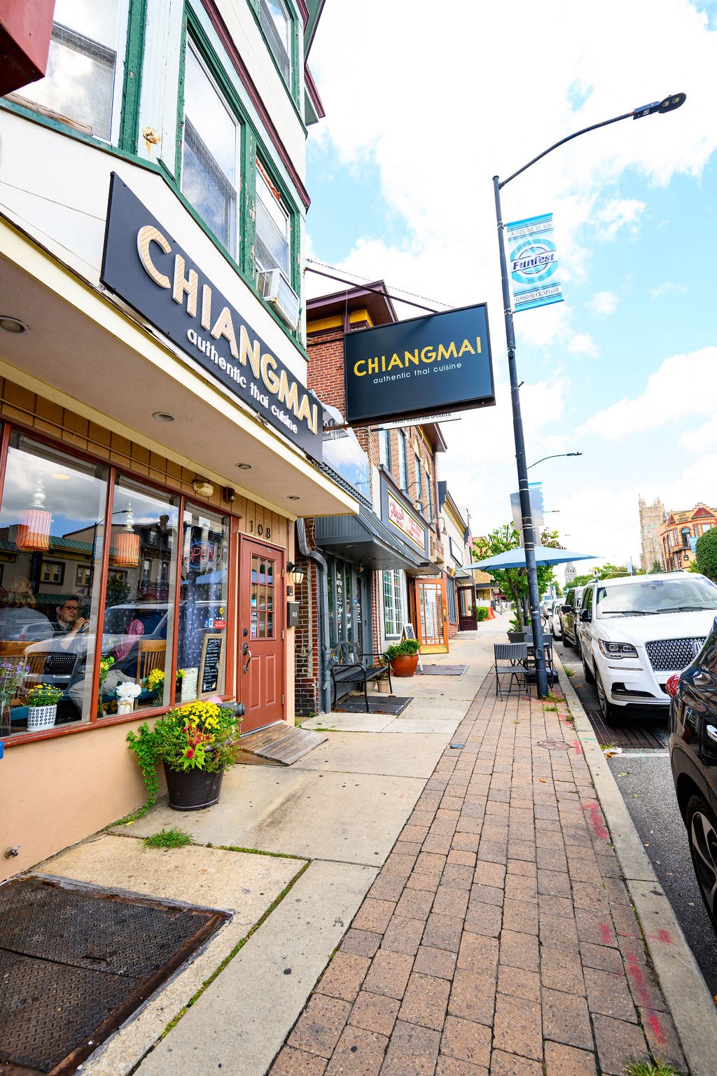a city street with a chiangmai sign on the side of a building at Madison West Elm, Conshohocken