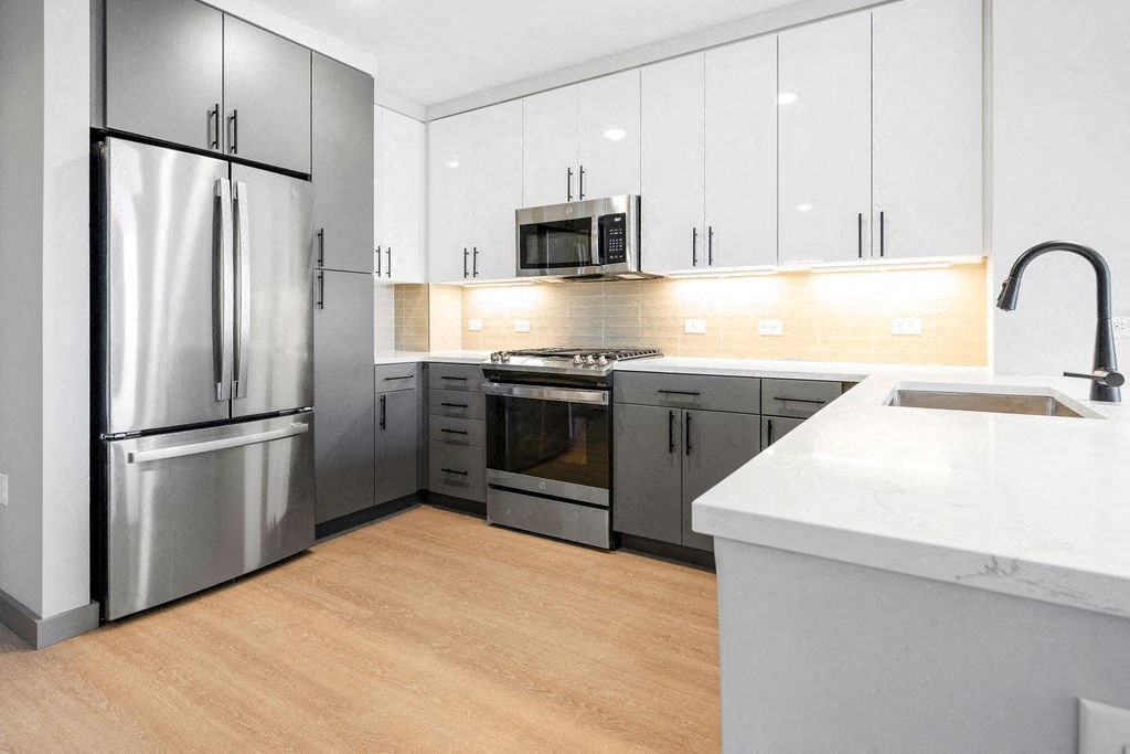a kitchen with stainless steel appliances and white cabinets at Madison West Elm, Pennsylvania, 19428