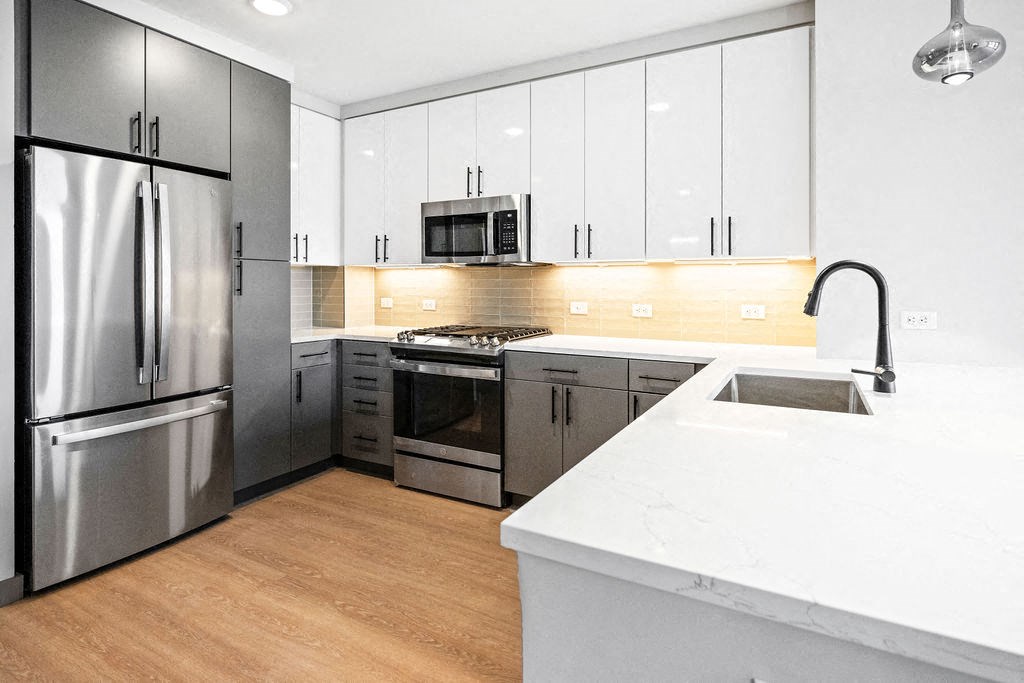 a large kitchen with stainless steel appliances and white counter tops at Madison West Elm, Pennsylvania, 19428