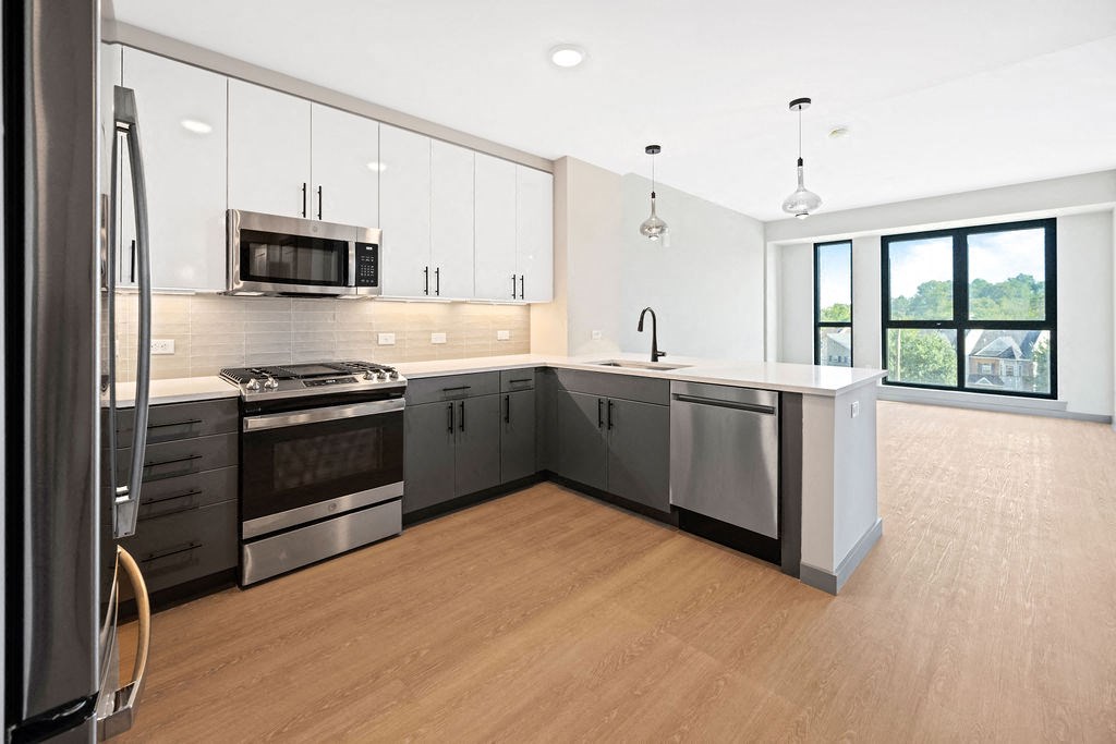 an image of a kitchen with stainless steel appliances and white cabinets at Madison West Elm, Conshohocken, PA