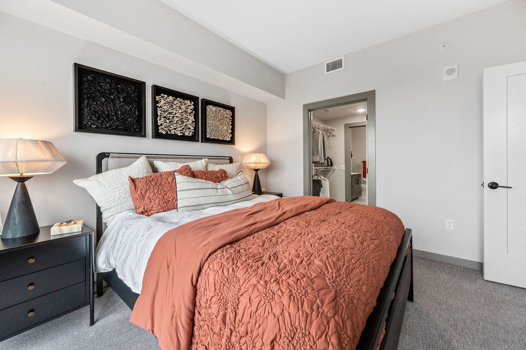 a bedroom with a bed and a door to a bathroom at Madison West Elm, Conshohocken, PA, 19428