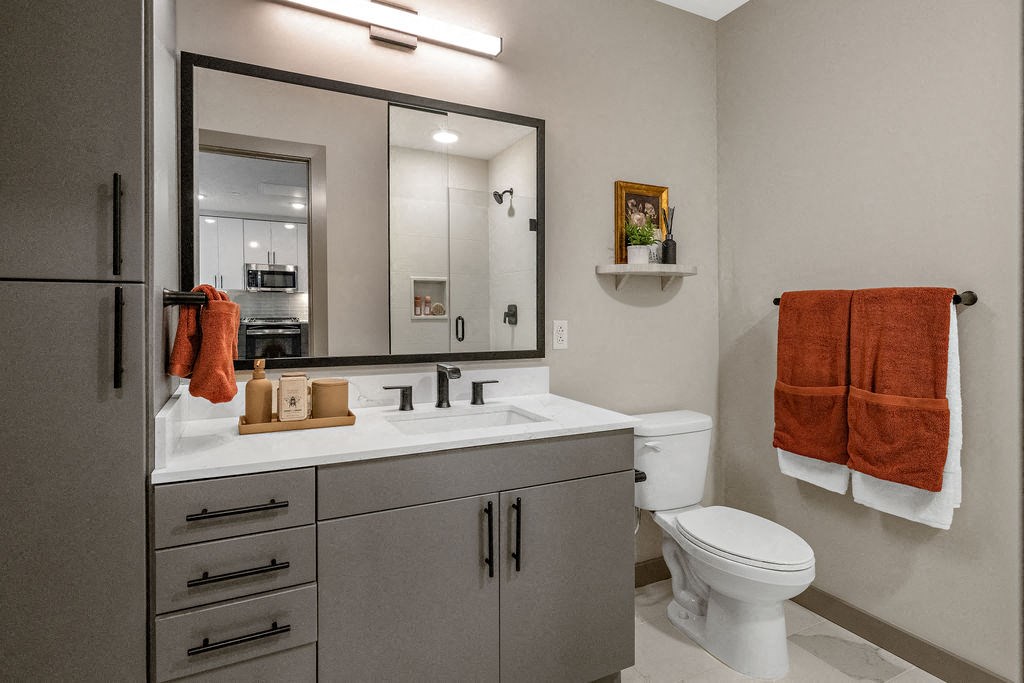 a bathroom with a sink toilet and a mirror at Madison West Elm, Pennsylvania