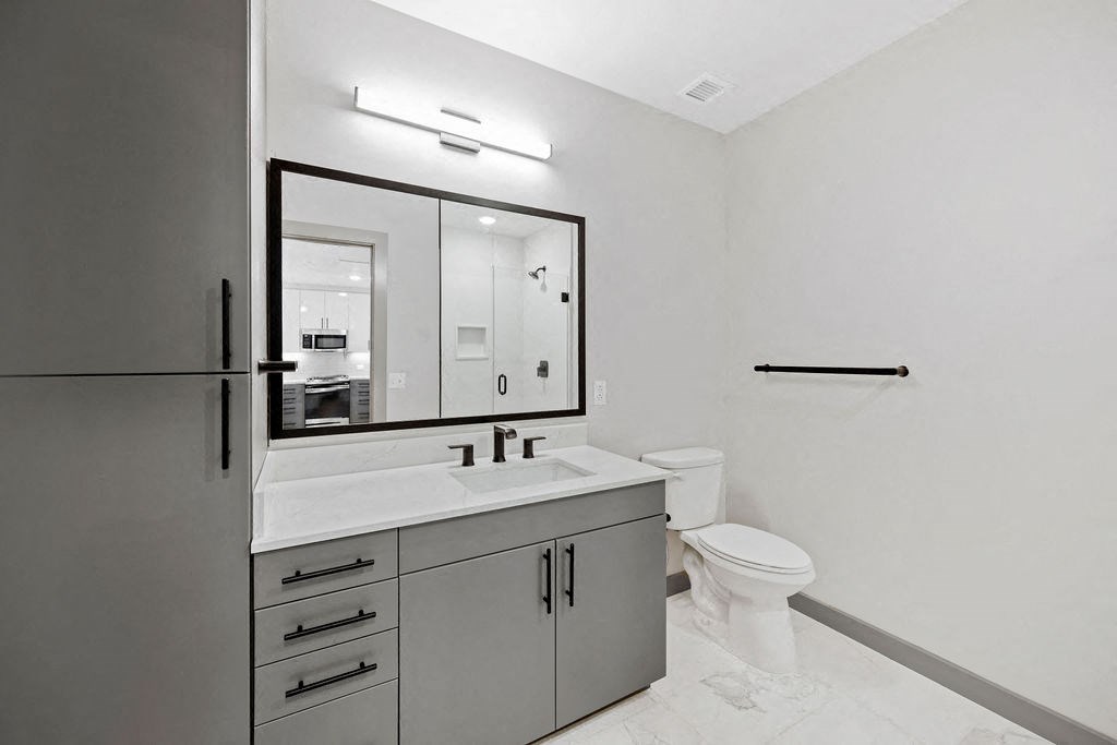 a bathroom with a sink toilet and a mirror at Madison West Elm, Conshohocken, PA, 19428