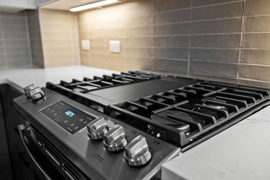 a kitchen with a stove top oven and a sink at Madison West Elm, Conshohocken, Pennsylvania