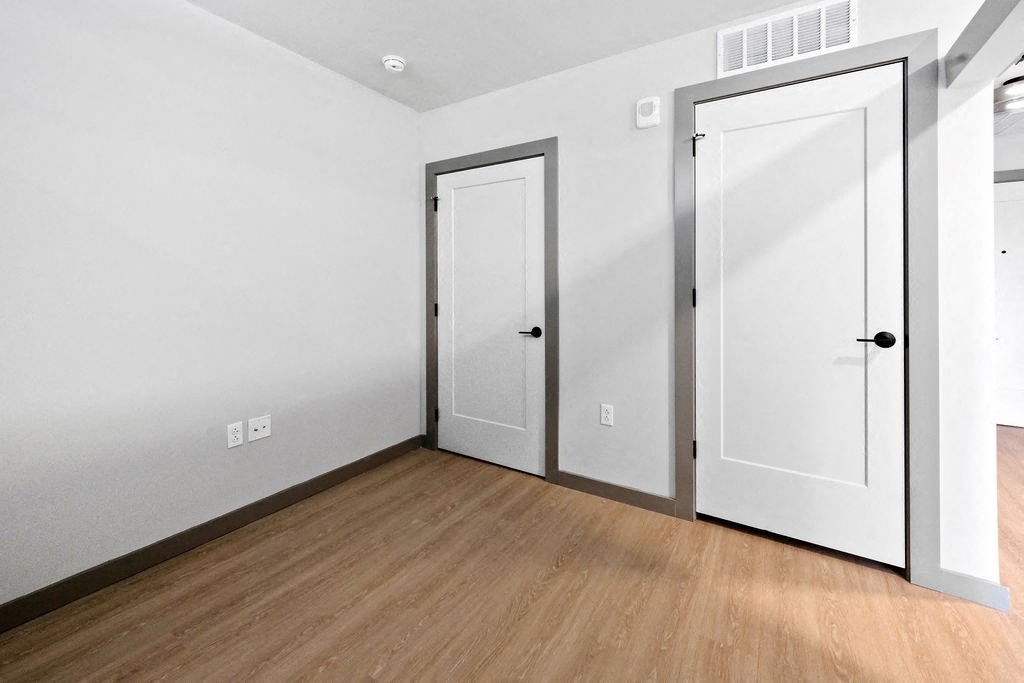 a bedroom with white doors and wood flooring at Madison West Elm, Pennsylvania