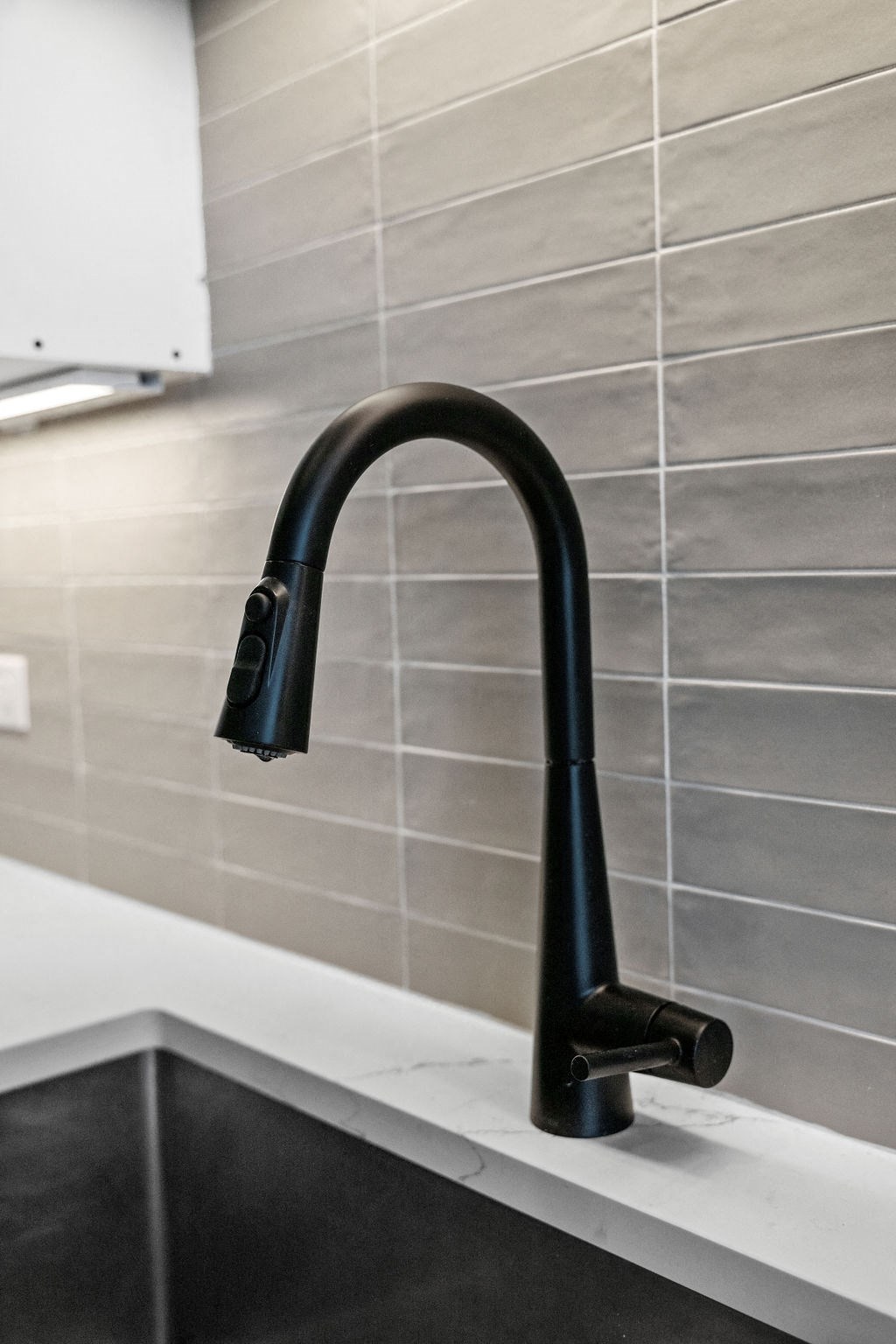 a close up of a black faucet in a kitchen sink at Madison West Elm, Pennsylvania
