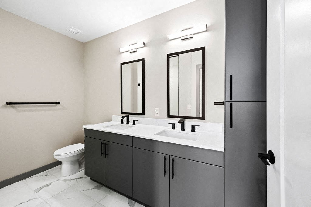 a black and white bathroom with two sinks and a toilet at Madison West Elm, Pennsylvania, 19428
