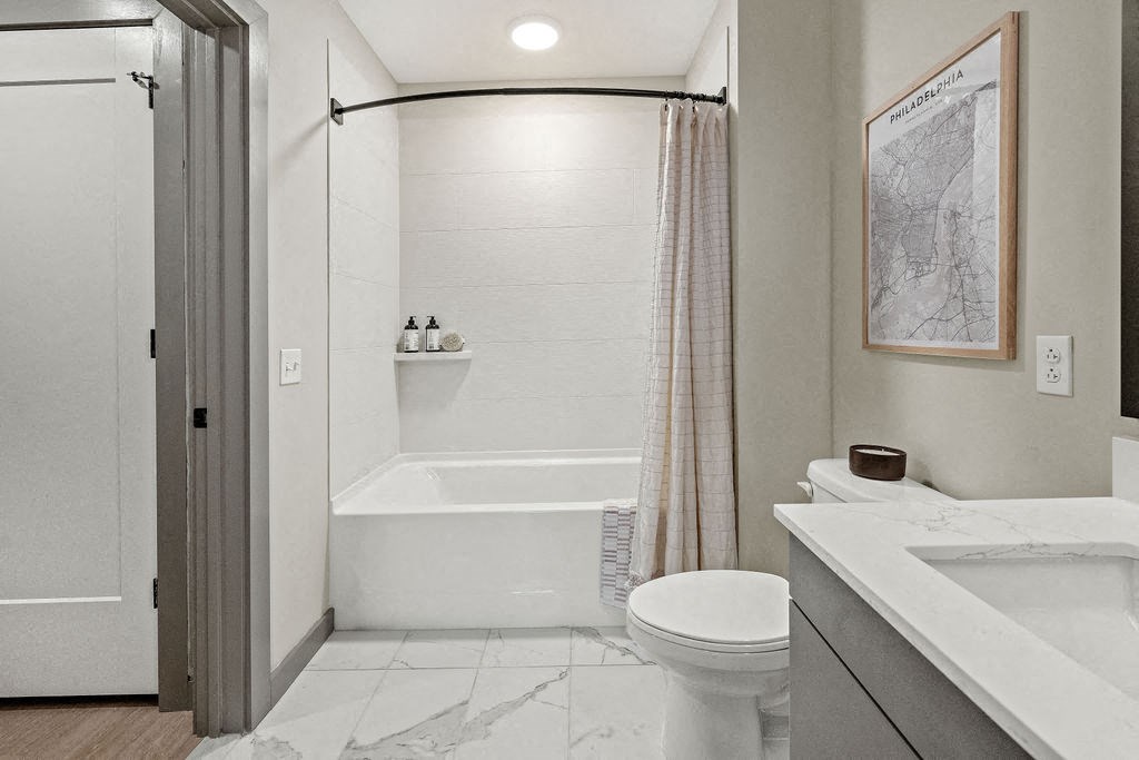 a bathroom with a urinal and a shower and a sink at Madison West Elm, Conshohocken, PA