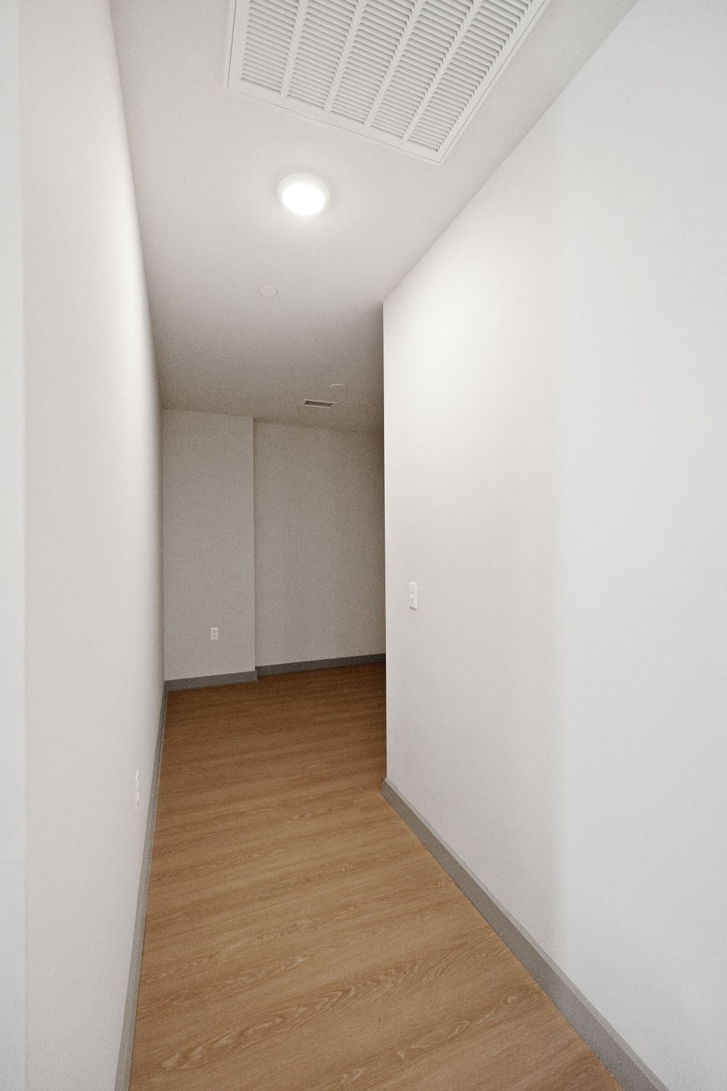 an empty room with white walls and wood floors at Madison West Elm, Conshohocken, Pennsylvania