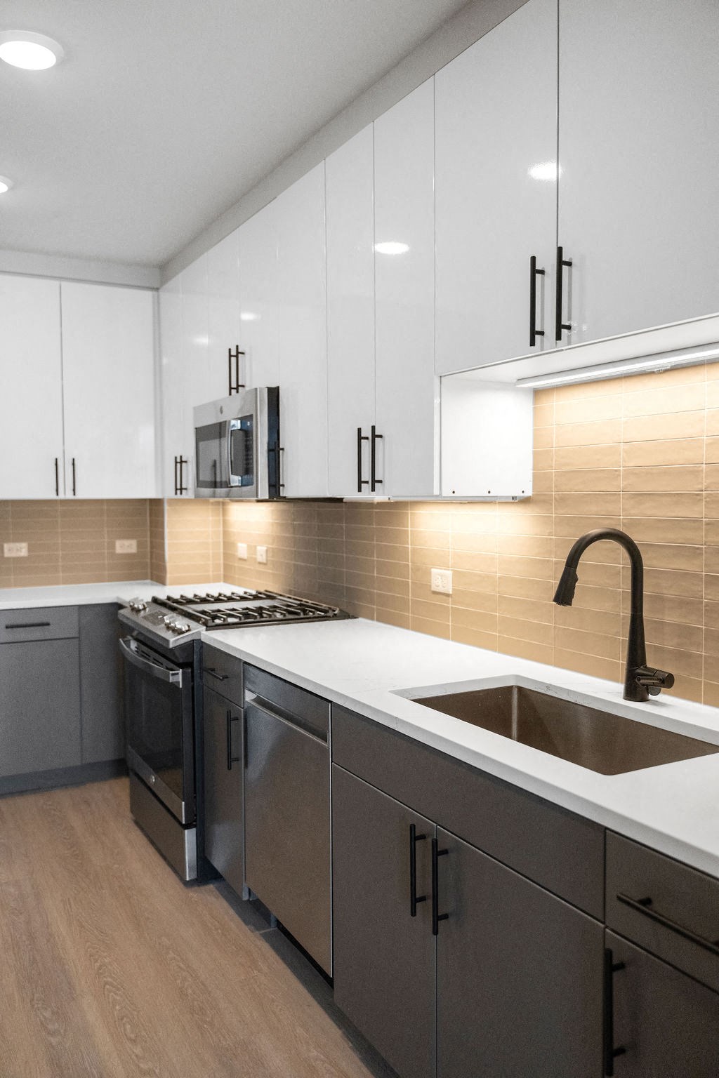 a kitchen with white cabinets and a sink and a stove at Madison West Elm, Conshohocken, PA, 19428