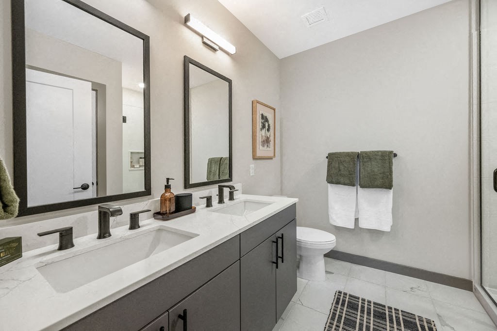 a bathroom with a toilet and a sink at Madison West Elm, Conshohocken, Pennsylvania