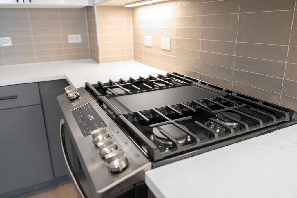 a kitchen with a stove and a counter top at Madison West Elm, Conshohocken, PA