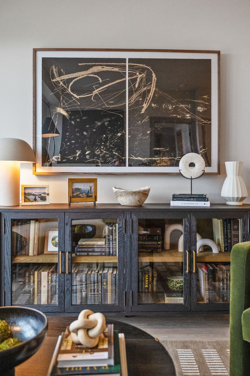 a living room with a black and white painting and a bookshelf with books at Madison West Elm, Conshohocken, Pennsylvania