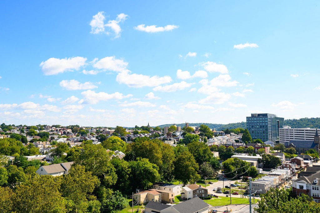 an aerial view of a city with trees and buildings at Madison West Elm, Conshohocken, Pennsylvania