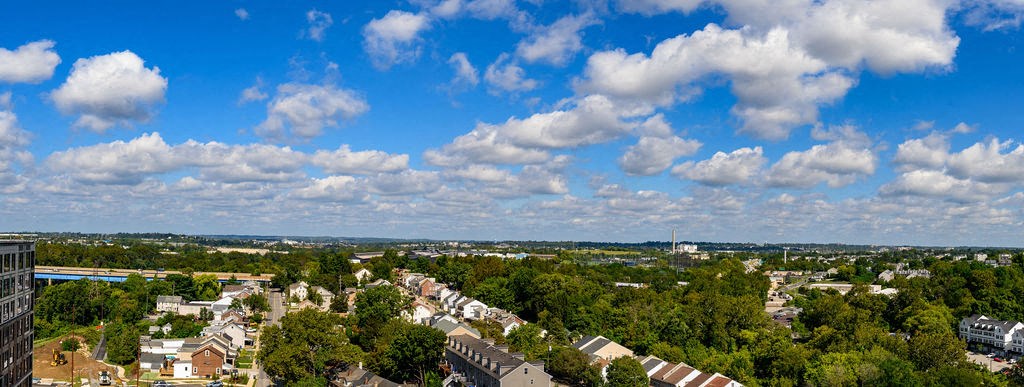 an aerial view of a city with clouds in the sky at Madison West Elm, Conshohocken, Pennsylvania