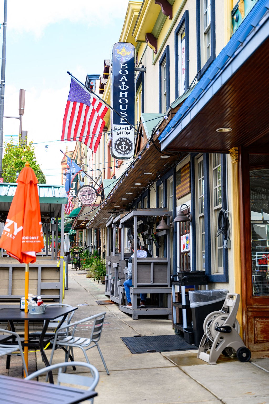 a city street with tables and chairs and flags at Madison West Elm, Pennsylvania