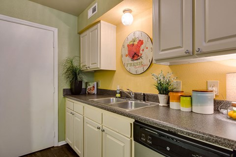 a kitchen with a sink and a refrigerator