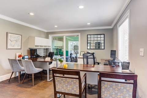 A dining room with a table and chairs.